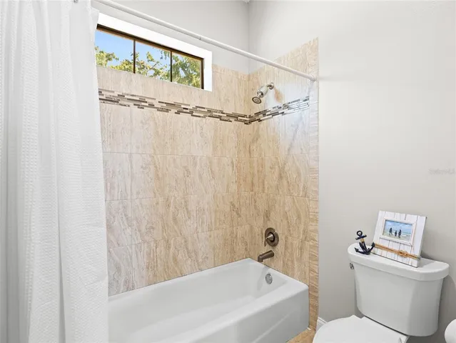 a bathroom with a bathtub and shower