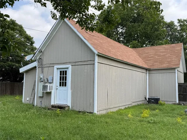 a view of backyard of house and deck