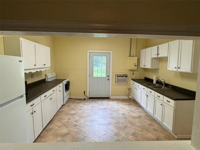 a large kitchen with a stove top oven