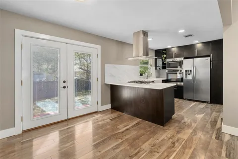 a kitchen with granite countertop a refrigerator and a sink