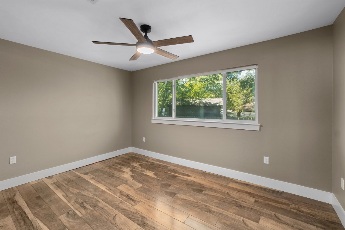 1204 Eleanor Street Austin, TX 78721 - Photo 17 of 27 a view of a big room with wooden floor and windows