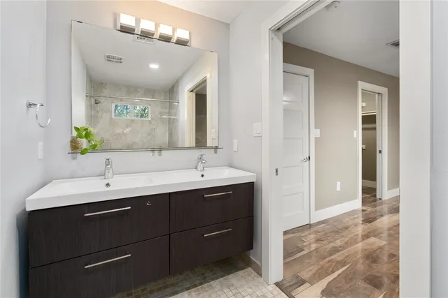 a bathroom with a double vanity sink and a mirror