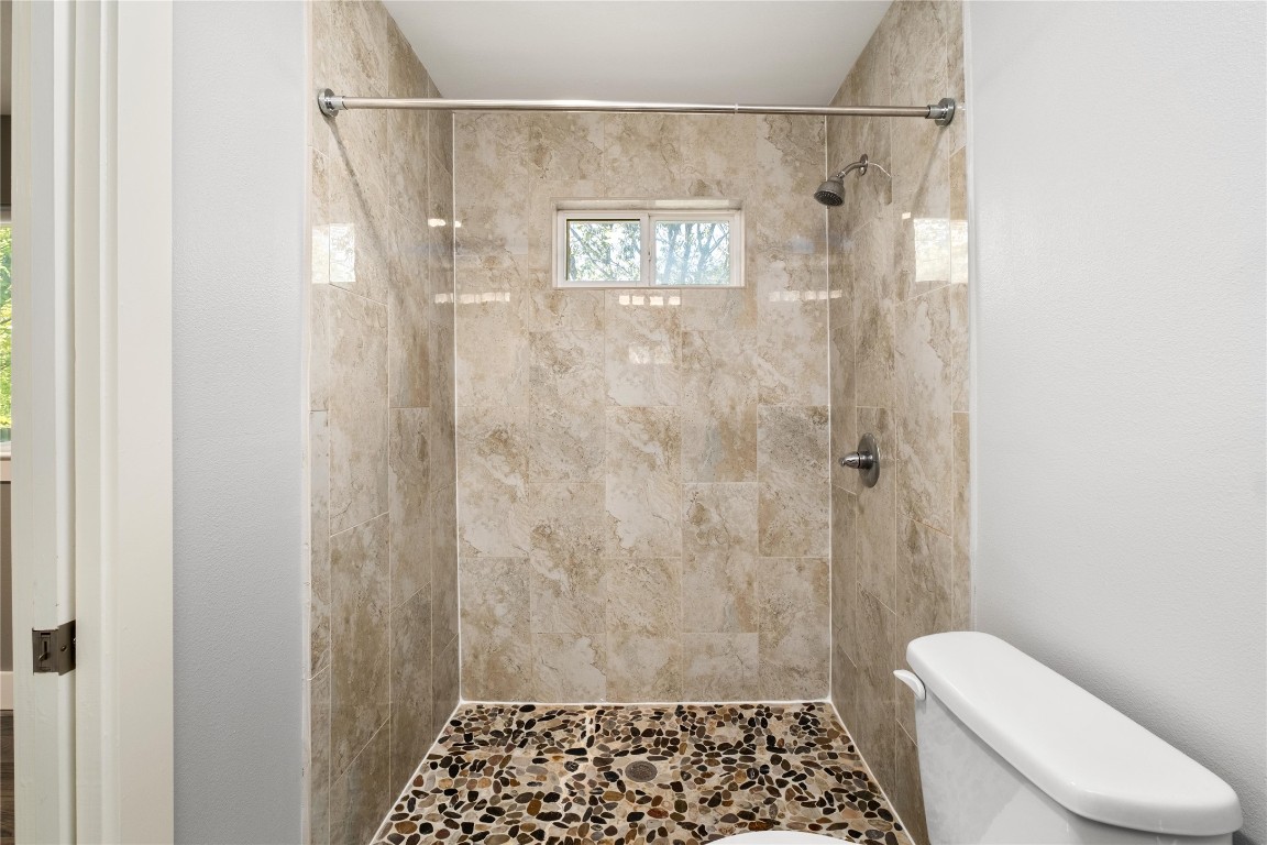 1204 Eleanor Street Austin, TX 78721 - Photo 19 of 27 a bathroom with a shower and toilet