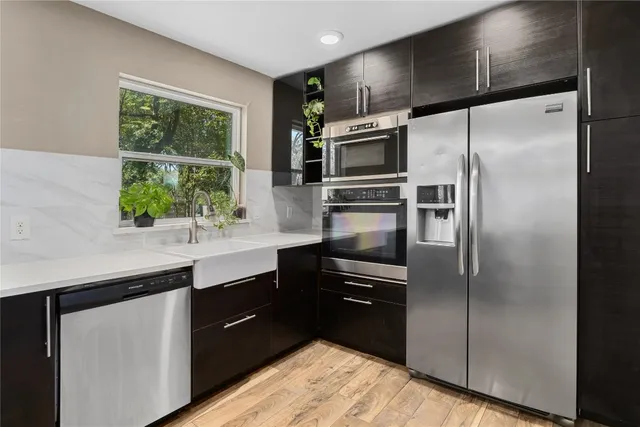 a kitchen with a refrigerator sink and microwave