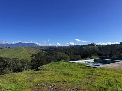 a view of a yard with swimming pool and mountains