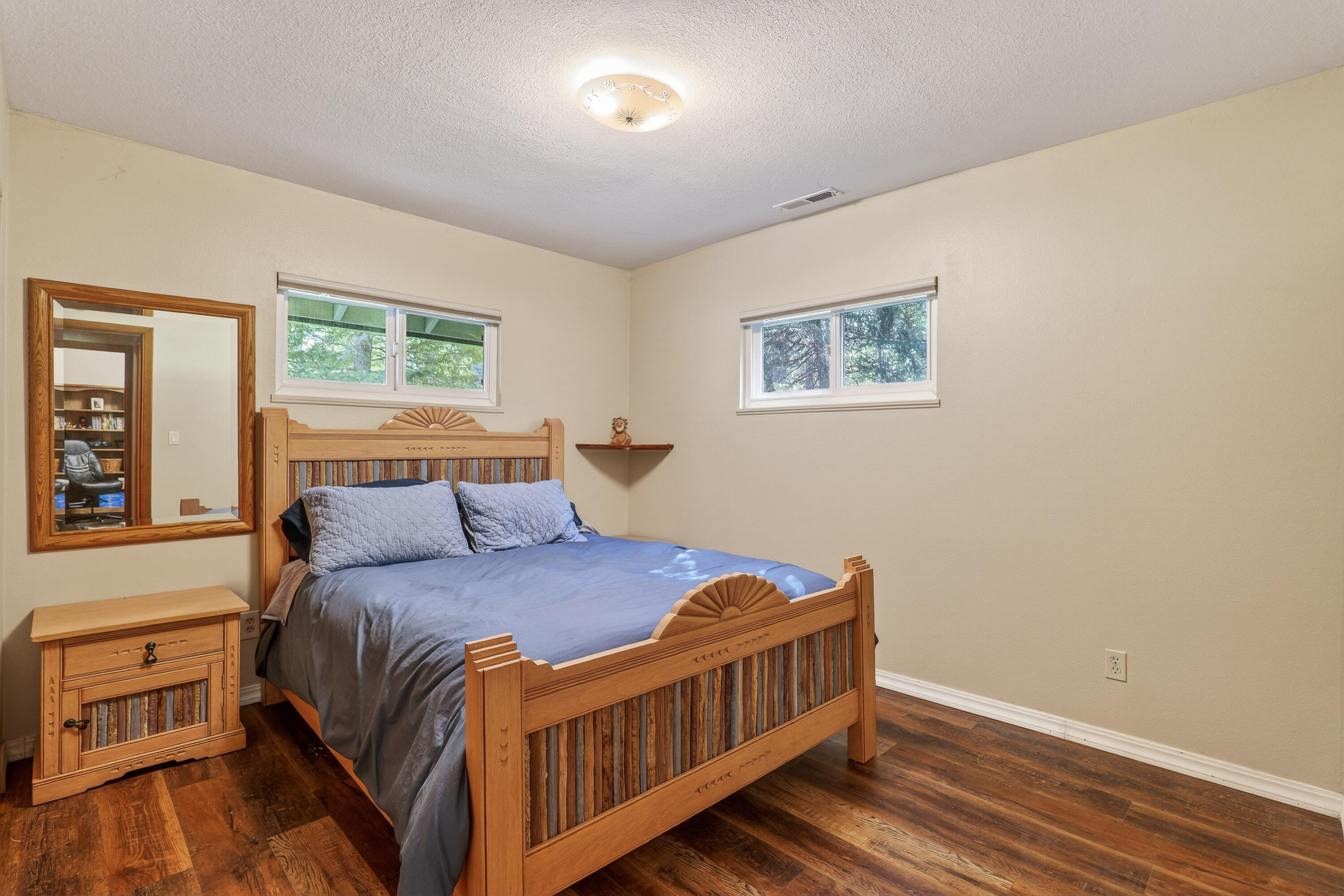 244 Riessen Road Grants Pass, OR 97526 - Photo 27 of 52 a bedroom with a bed and wooden floor