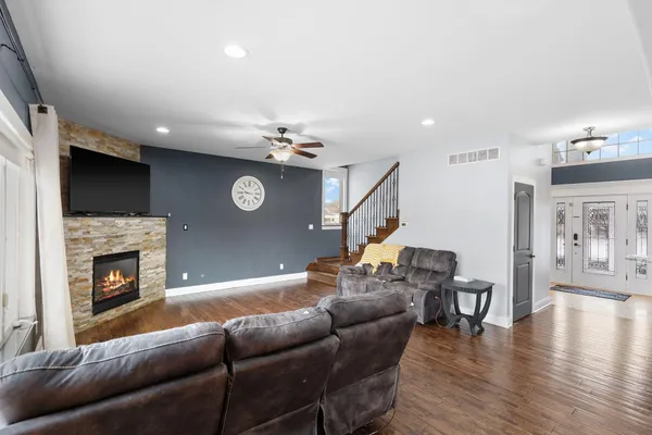 a living room with furniture fireplace and flat screen tv