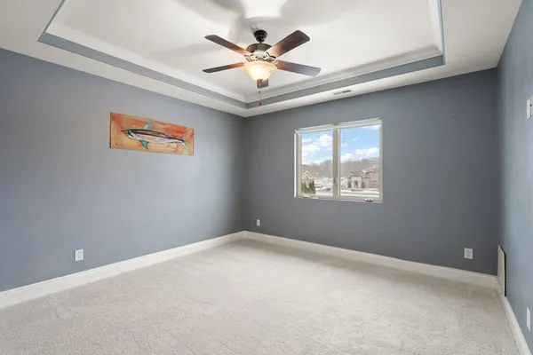 a bedroom with a bed and a ceiling fan