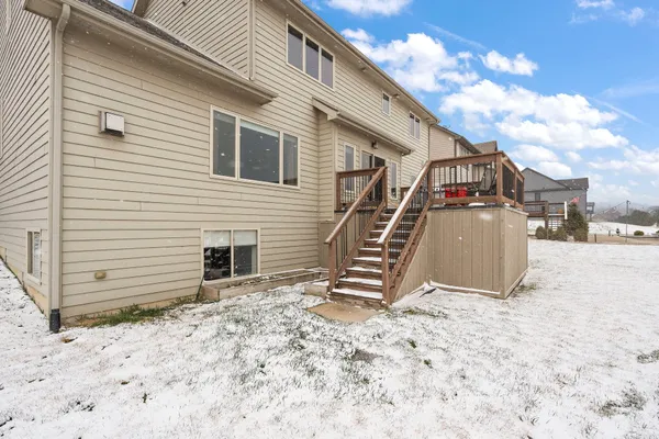 a view of houses with snow on the road