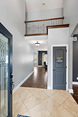 a view of kitchen with kitchen island stainless steel appliances refrigerator stove microwave and cabinets