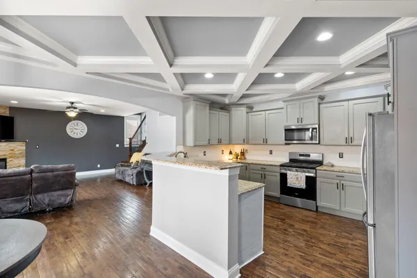 a kitchen with stainless steel appliances granite countertop a sink stove and microwave
