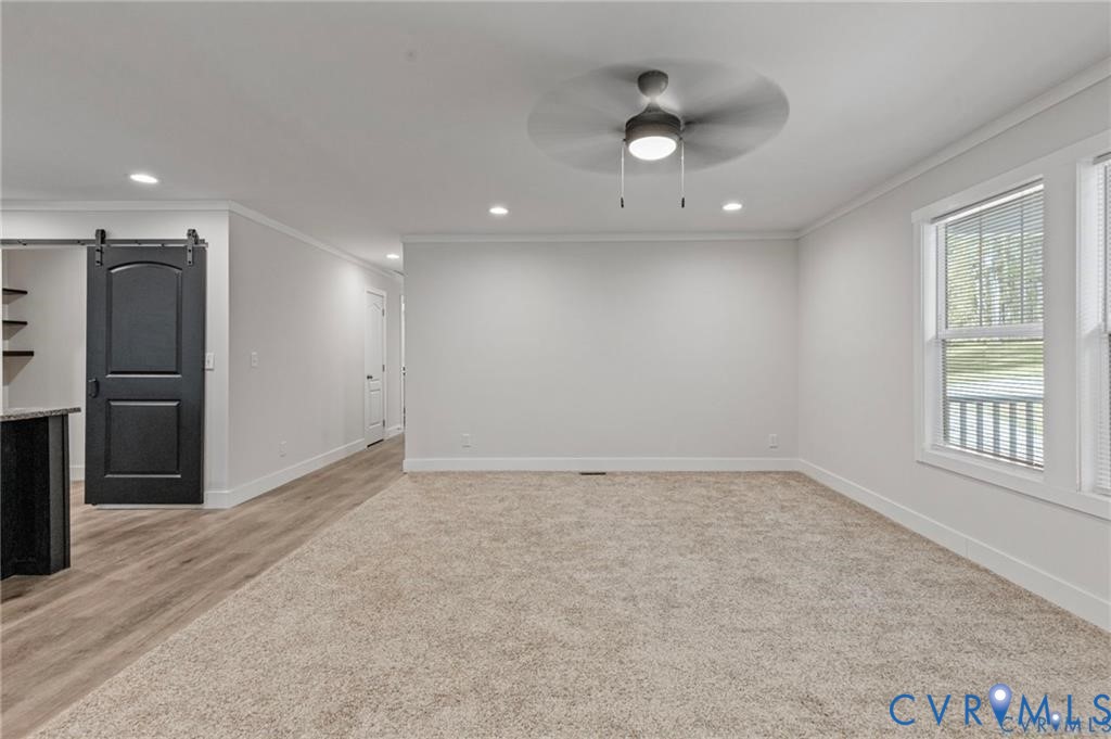 6584 Blenheim Road Powhatan, VA 23139 - Photo 5 of 31 Spare room with a barn door, crown molding, a ceil
