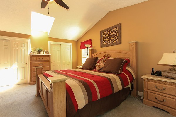 230 Winding Pond Road, Unit 230 Londonderry, NH 03053 - Photo 11 of 30 a bed room with a bed and furniture