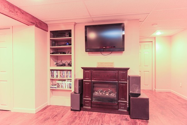 230 Winding Pond Road, Unit 230 Londonderry, NH 03053 - Photo 17 of 30 a living room with furniture and a flat screen tv