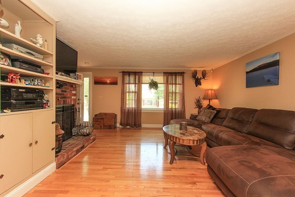 230 Winding Pond Road, Unit 230 Londonderry, NH 03053 - Photo 3 of 30 a living room with furniture and a flat screen tv