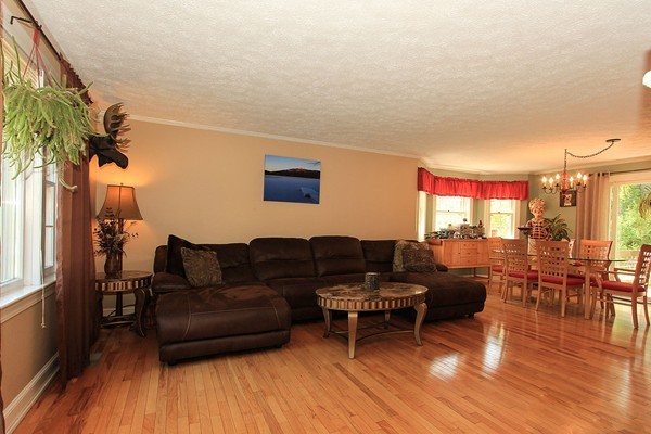 230 Winding Pond Road, Unit 230 Londonderry, NH 03053 - Photo 4 of 30 a living room with furniture and a wooden floor