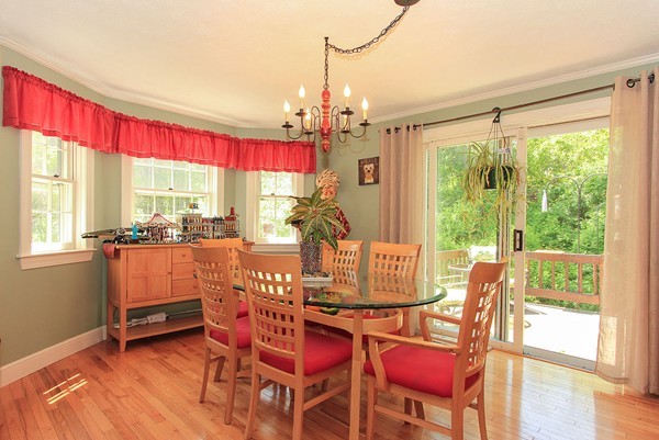 230 Winding Pond Road, Unit 230 Londonderry, NH 03053 - Photo 5 of 30 a dining room with furniture a chandelier and wooden floor
