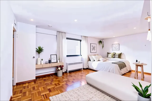 a bedroom with furniture and wooden floor