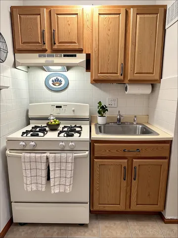 a kitchen with stove and cabinets