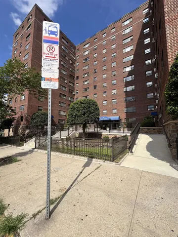 a street sign on a sidewalk next to a building