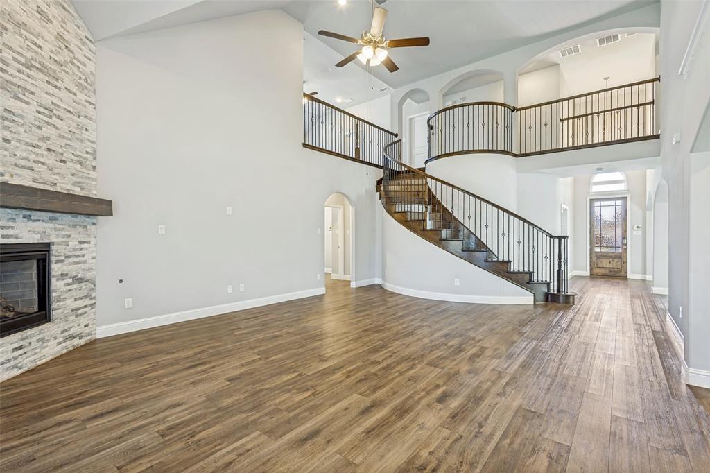 212 Wandering Way Anna, TX 75409 - Photo 12 of 36 a view of staircase with white walls and a floor to ceiling window