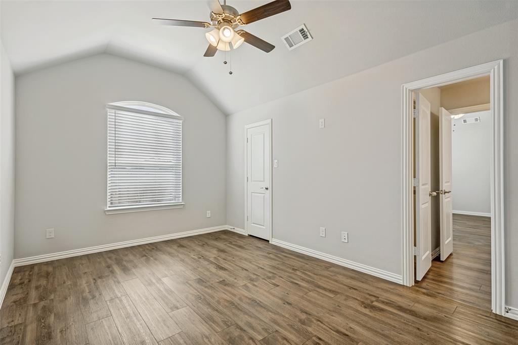 212 Wandering Way Anna, TX 75409 - Photo 19 of 36 a view of an empty room with wooden floor and a window