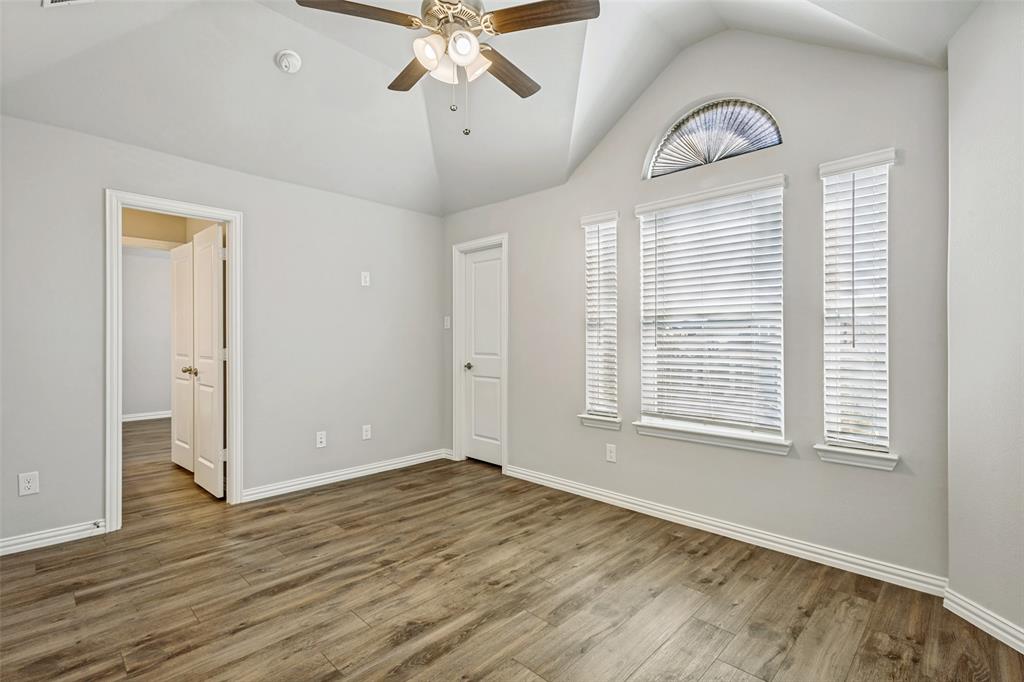 212 Wandering Way Anna, TX 75409 - Photo 20 of 36 a view of an empty room with wooden floor and a window