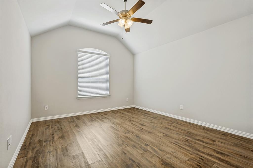 212 Wandering Way Anna, TX 75409 - Photo 25 of 36 a view of an empty room with window and wooden floor