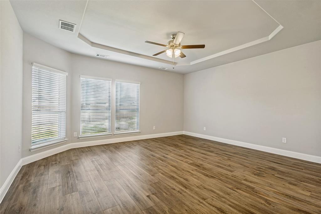 212 Wandering Way Anna, TX 75409 - Photo 30 of 36 a view of an empty room with wooden floor and a window