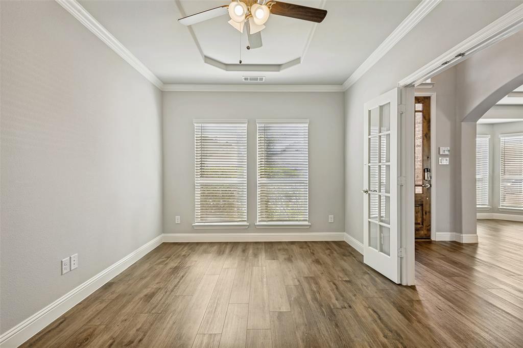 212 Wandering Way Anna, TX 75409 - Photo 3 of 36 a view of an empty room with wooden floor and a window