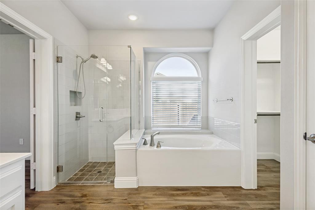 212 Wandering Way Anna, TX 75409 - Photo 32 of 36 a white bath tub sitting next to a bathroom sink