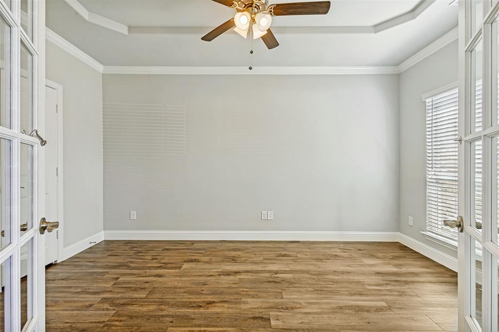 212 Wandering Way Anna, TX 75409 - Photo 4 of 36 a view of a room with wooden floor and white walls