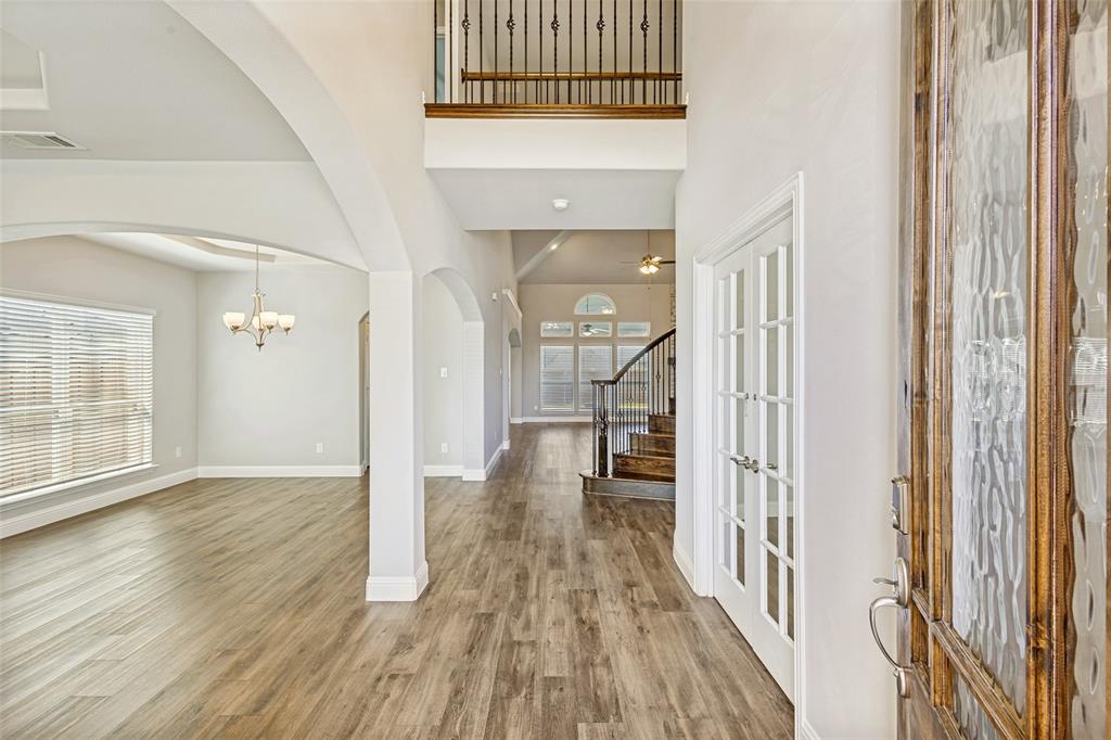 212 Wandering Way Anna, TX 75409 - Photo 5 of 36 a view of a hallway with wooden floor and staircase