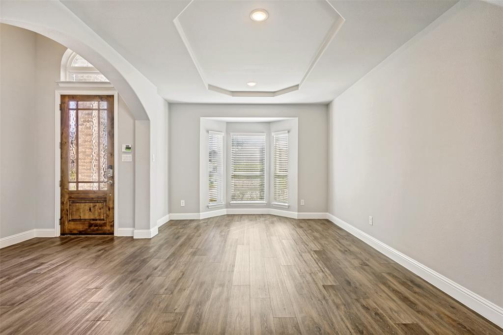 212 Wandering Way Anna, TX 75409 - Photo 8 of 36 wooden floor in an empty room with a window