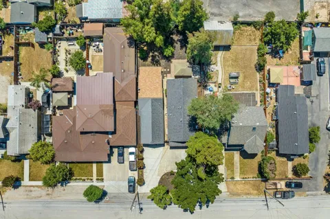 an aerial view of residential houses with outdoor space