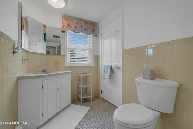 a bedroom with two beds and a window