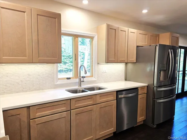 a kitchen with stainless steel appliances granite countertop a stove and a sink