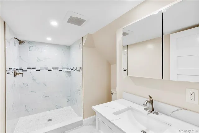 a bathroom with a tub sink and mirror