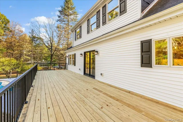 an empty room with windows and fireplace