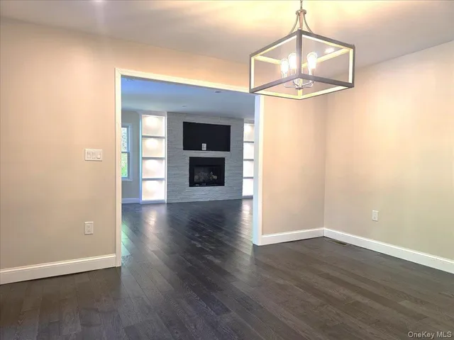 a large white kitchen with a large window