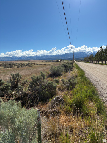650 East 950th Street North, Unit E HALF Spring City, UT 84662 - Photo 1 of 1 Expansive landscape featuring distant mountains, a long unpaved road, and natural vegetation