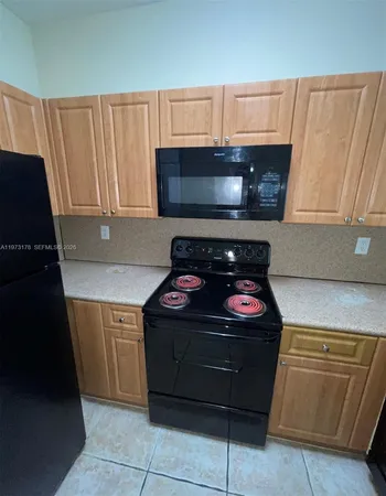 a kitchen with a stove and a microwave