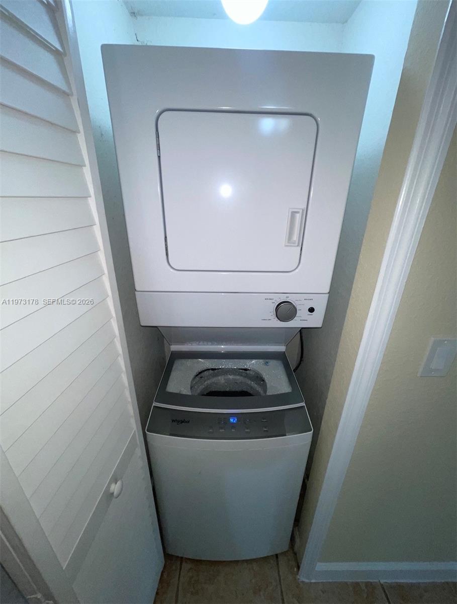 1661 Southeast 29th Court, Unit 109 Homestead, FL 33035 - Photo 8 of 18 a bathroom with a sink and a washer dryer