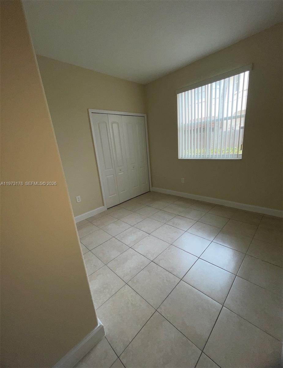 1661 Southeast 29th Court, Unit 109 Homestead, FL 33035 - Photo 9 of 18 an empty room with windows