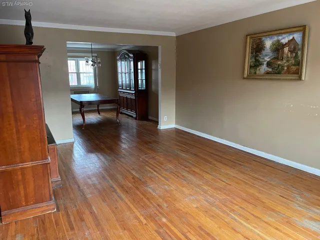 a view of a living room with wooden floor