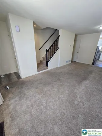 a view of an empty room with stairs