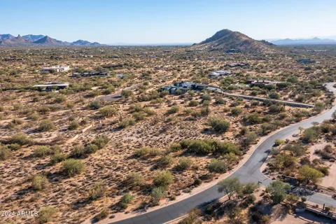 an aerial view of residential houses with city view