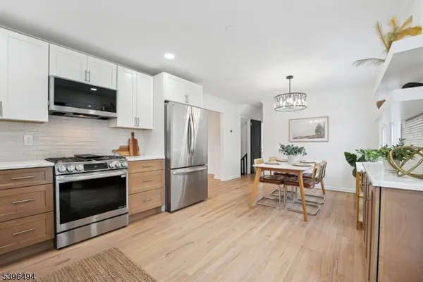 a kitchen with stainless steel appliances a stove a sink and a refrigerator