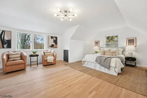 a spacious bedroom with a bed a couch and a window