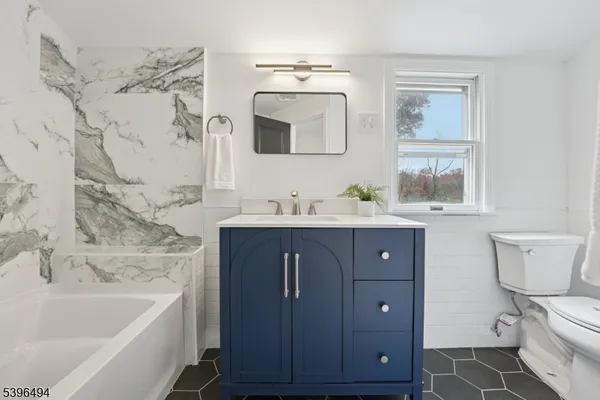 a bathroom with a sink a toilet and bathtub